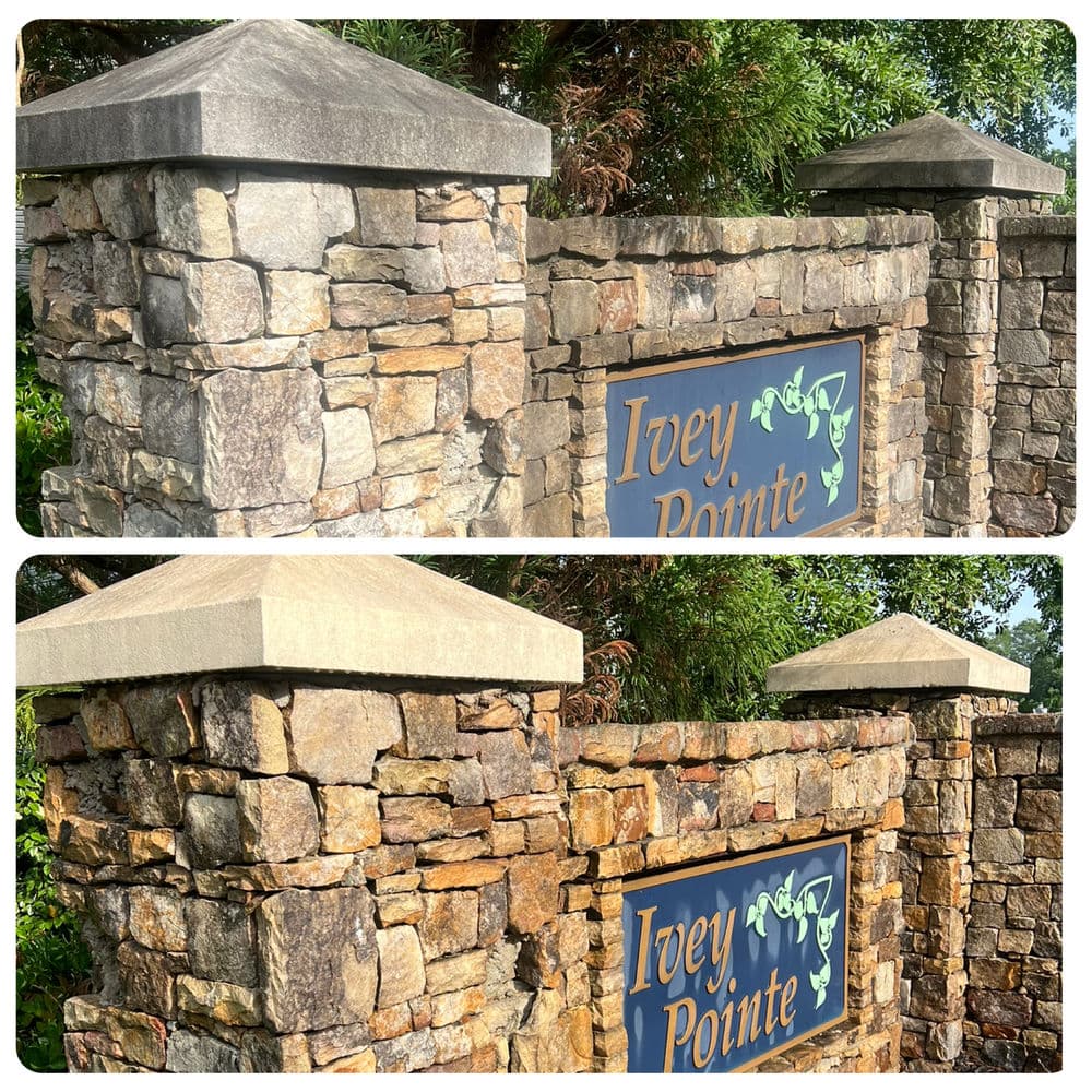 Stone entrance pillars of Ivey Pointe with blue and green signage amid lush greenery.