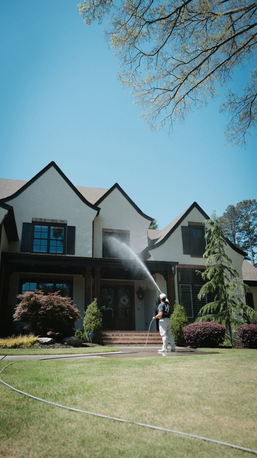 Soft washing the front of a two-story home