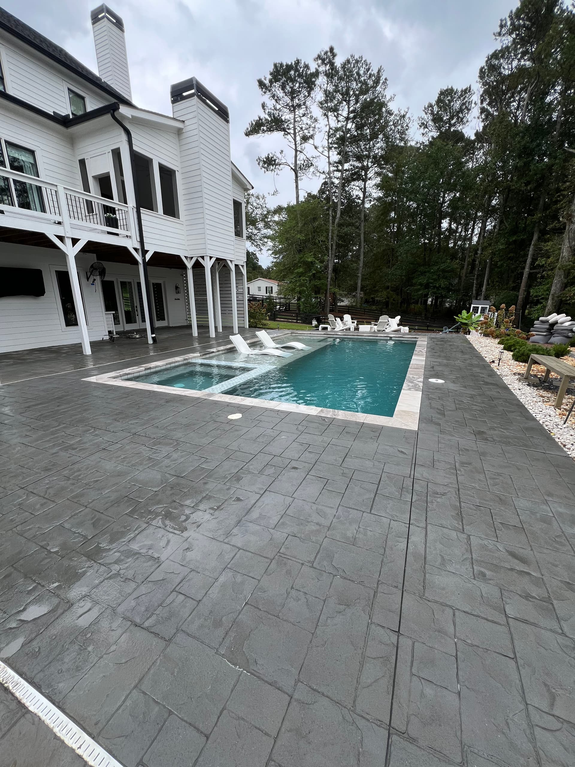 Pool Deck Cleaning in Lush Backyard Oasis image